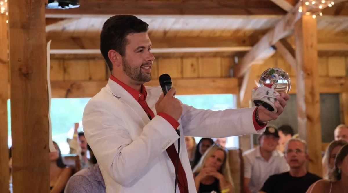 Cam Labrecque holding the cardinal snowglobe that inspired Rememery